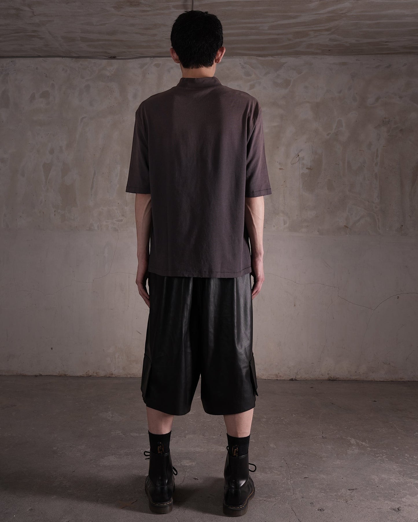 KYOHEY_FUJITAのヘビーウォッシュ加工モックネックTシャツを着用した男性の背面ショット