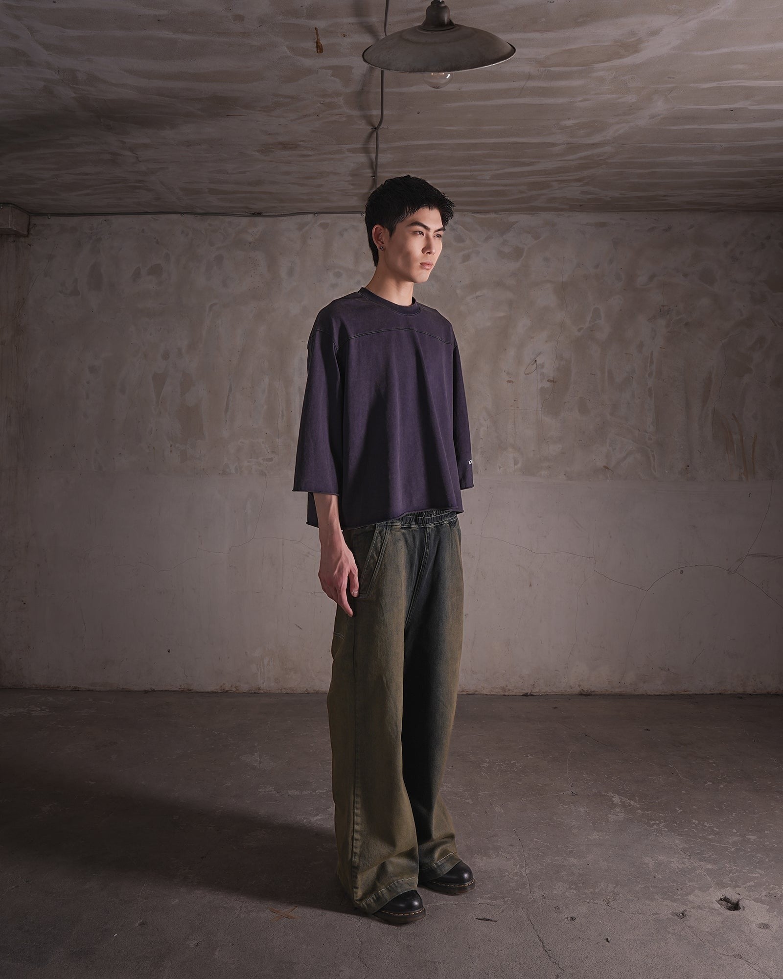 KYOHEY_FUJITAのヘビーガーメントウォッシュ加工が施されたストレートレッグジーンズを着用した男性モデル